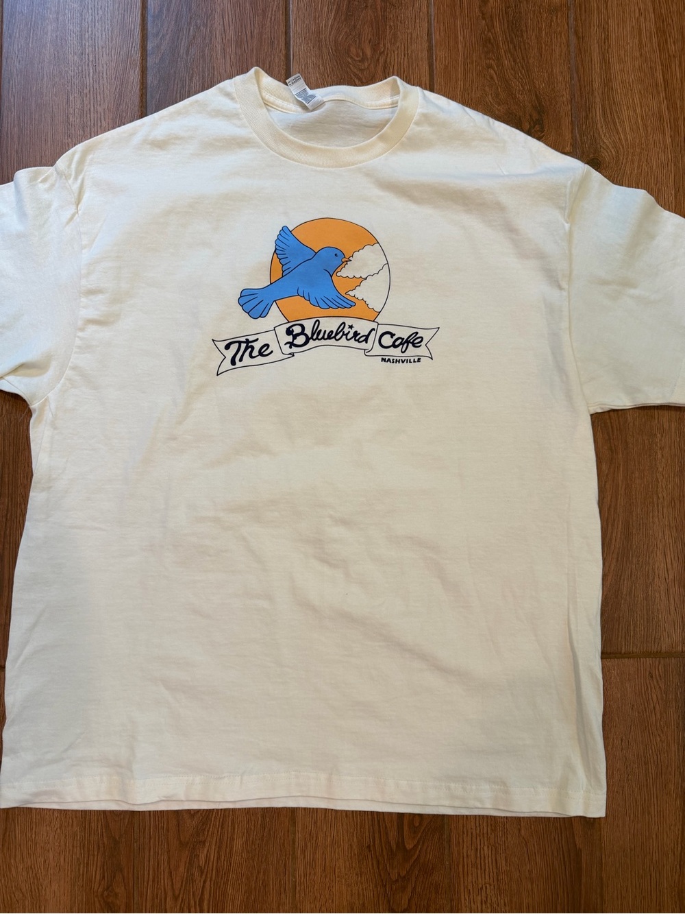 The Bluebird Cafe Graphic Tee - Cream with Blue & Orange Logo / XL
